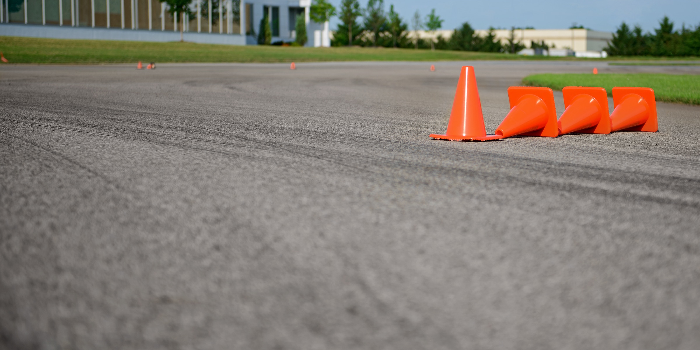 A line of orange traffic cones on a test track