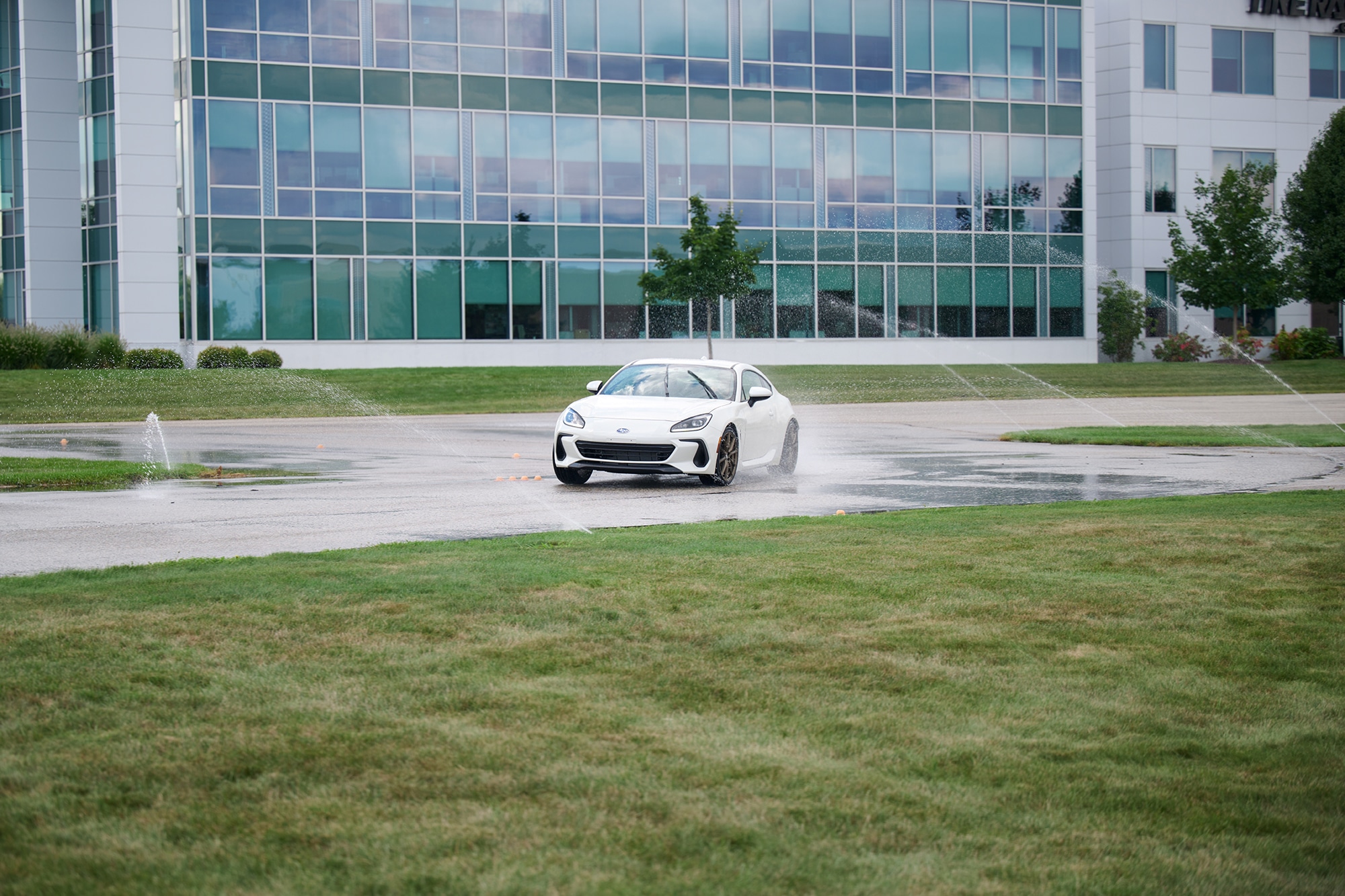 A white 2022 Subaru BRZ Limited conducting wet track testing