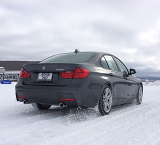 Wide shot of a BMW accelerating through the snow.