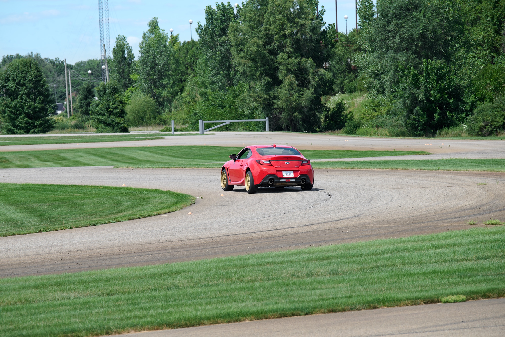 A red 2022 Subaru BRZ Limited with Enkei Racing RPF1 (Gold Painted) wheels